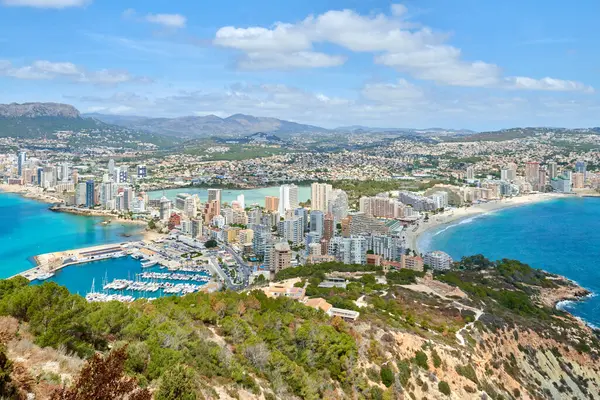 stock image Breathtaking Aerial View Calpe Spain Mediterranean Coastline Penon de Ifach Rock Lush Vegetation Sunny Day Tourism Paradise