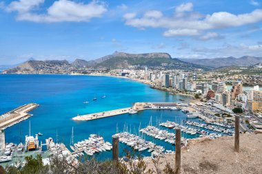 Majestic Cliffside Vantage Point Overlooking Calpes Stunning Coastline Pristine Beaches Bustling Marina Sunny Day Tourism Hotspot. Picturesque Mediterranean Seascape from Calpe Cliffs Featuring clipart