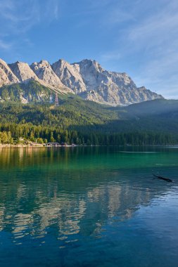 Bu nefes kesici görüntü, Eibsee 'nin dingin güzelliğini gözler önüne seriyor. Zugspitze' nin eteklerinde, Almanların en yüksek tepesinde kurulmuş bir alp gölü. Gölün berrak suları mükemmel bir şekilde yansıyor.