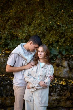 Genç Sevimli Kadın Hugs erkek. Sonbahar açık. Lovers Park'ta yürüyordunuz. Çekici komik çift. Ormandaki lovestory. Erkek ve kadın. Parkta şirin severler. Aile kavramı. Mutlu çift.