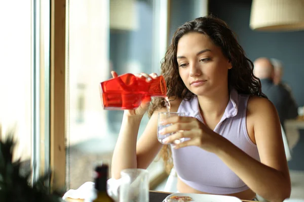 Woman Filling Glass Water Bottle Sitting Restaurant — Stock Photo, Image