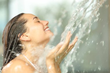Happy woman enjoying water in spa