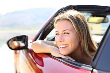 Happy car convertible driver laughing looking away