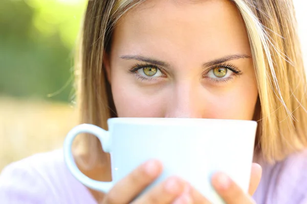 stock image Front view portrait of a beauty woman eyes looking at you with coffee cup outdoors