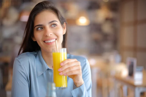 Happy Pensive Woman Drinking Orange Juice Bar Looking Side — Stock Photo, Image