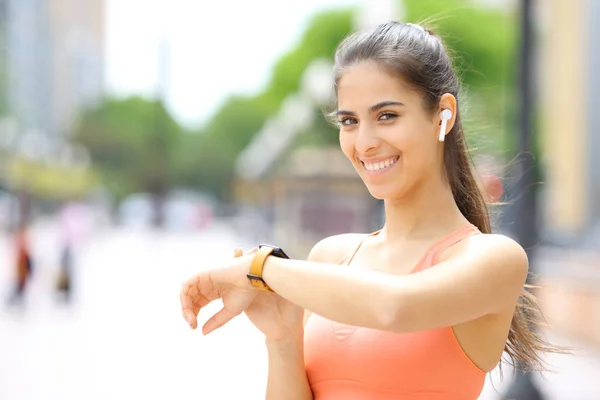 Runner Wearing Earbud Smartwatch Selecting Music Looking You Street — Stock Photo, Image