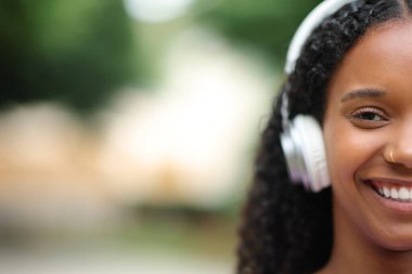 Kulaklık takan mutlu siyahi bir kadının portresi.