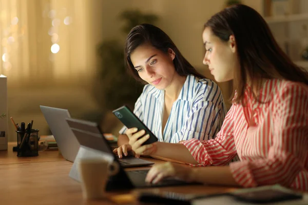 Two Tele Workers Using Multiple Devices Checking Phone Working Night — Stock Photo, Image