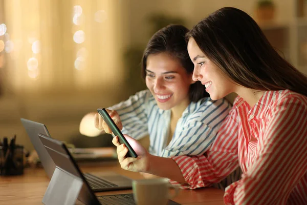 Two Happy Women Using Multiple Devices Checking Smart Phone Night — Stock Photo, Image