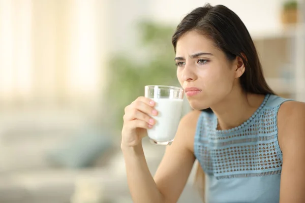 Disgusted Woman Smelling Expired Milk Home — Stock Photo, Image
