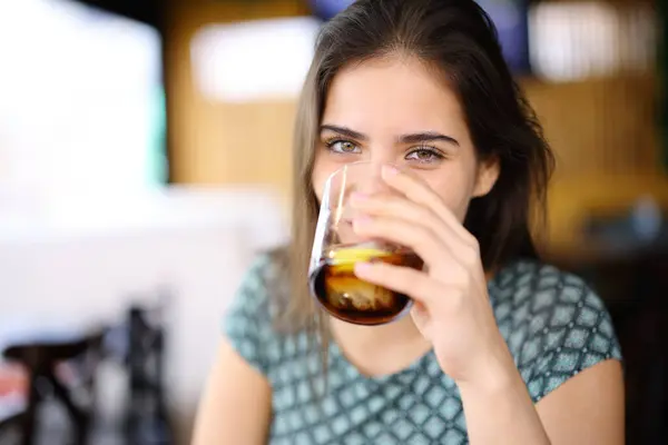 Happy Woman Drinking Soda Looking You Sitting Bar Interior — Stock fotografie