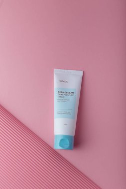 Izmail, Ukraine. March 2022. IUNIK Beta-glucan daily moisture cream, brightening and wrinkle care. Skin Korean cosmetics. Tube on pink