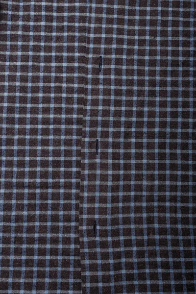 dark blue checkboard pattern shirt fabric background, garment texture with buttons, vertical shot