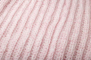 Açık pembe yün örgü desenli örgü, örülmüş arka plan. Soyut süveter yüzeyi, örülmüş iplik.