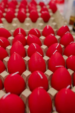 Karton yumurta kutusunda kırmızı yumurta şeklinde mumlar. Paskalya dekoru.