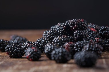 Kahverengi ahşap masa zemininde taze böğürtlen, yakın plan çekim, kopyalama alanı.