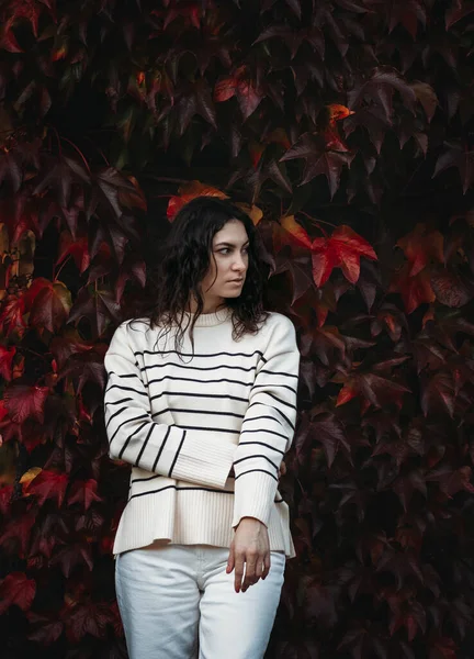 stock image Fashion woman on a background of red and yellow autumn leaves