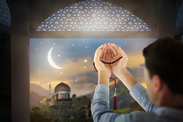 stock image Ramadan Kareem greeting. Man with prayer beads in mosque. Muslim male praying. Quran reading and pray. End of fasting. Hari Raya day. Eid al-Fitr celebration. Breaking of holy fast day. 