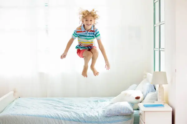 Ребенок Прыгает Кровати Белой Спальне Большим Окном Дети Играют Дома — стоковое фото