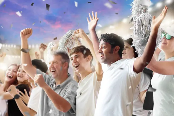 stock image Football supporter on stadium in black and white shirt. Happy fans on soccer pitch watching winning team play. Group of supporters cheering excited. Championship game. Victory party crowd.