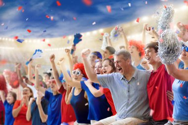 Football supporter on stadium in red and blue shirt. Happy fans on soccer pitch watching winning team play. Group of supporters with flag and jersey cheering excited. Championship game. Victory party clipart