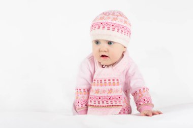 Beyaz güneşli yatak odasında sevimli bir bebek. Beyaz arka planda küçük bir kız. Küçük çocuklar için çocuk odası. Çocuklar için tekstil ve yatak. Aile sabahı evde. Yeni doğan çocuk.