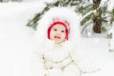 Çocuklar kış parkında karda oynarlar. Çocuklar karlı soğuk bir günde dışarıda oynuyorlar. Oğlan ve kız kızakla gezerken eğleniyorlar. Noel tatili aktivitesi. Kış havasında açık hava eğlencesi. Çocukla seyahat et..