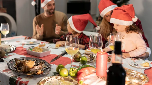 Caucasian Family Four Santa Hats Celebrating Christmas Dinner Focus Candle — Stock Photo, Image
