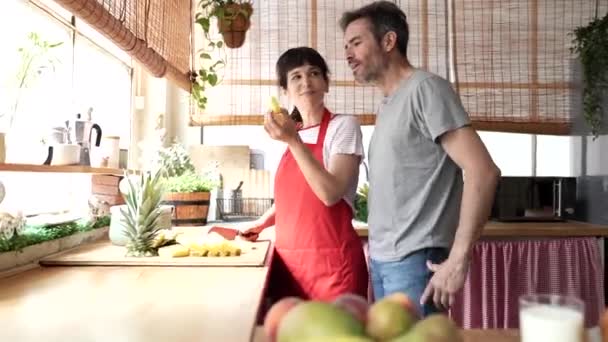 Happy Mature Couple Home Kitchen Preparing Food Cutting Pineapple Domestic — 图库视频影像