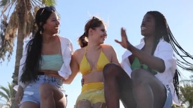 Happy female friends having fun and eating fresh pineapple fruit at boat party on the beach -Concept of youth, tropical, travel and summer vacation