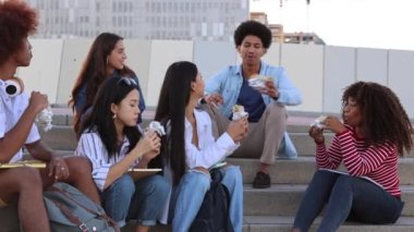 multiracial group of college students walking out of college