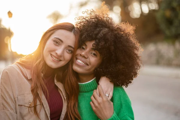 portrait of two multiracial women together, lesbian couple, at sunset