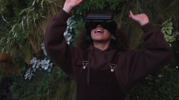 Pretty African American Woman Uses Virtual Reality Glasses Vertical Garden — Video