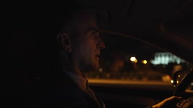 mature businessman driving at night