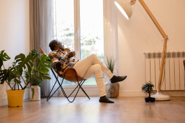 retired mature man enjoying a hot drink at home