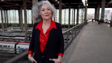 senior business woman, she is walking to catch a train, work trip.