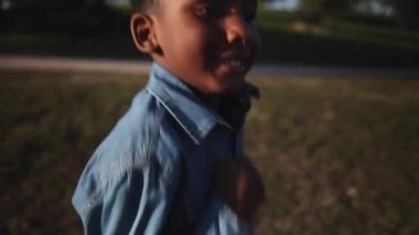 African boy in public park running happily