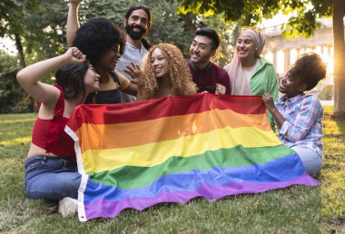 Diverse young friends celebrating gay pride festival - LGBTQ community concept - group of multiracial people of different sexual orientations
