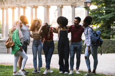 group of diverse people travelers, backpackers in the new city are walking around the city