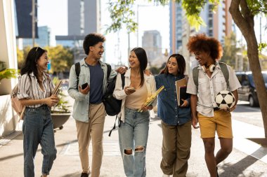 Diverse friends walking in the city - students in the city campus, travelers.