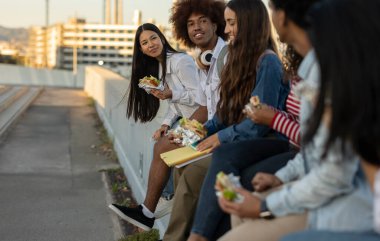 group of traveling friends eating in the city - focus on asian woman -