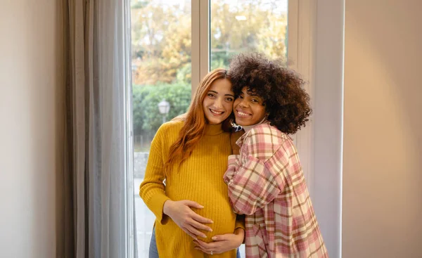 lesbian couple, pregnant woman, maternity multiracial gay women
