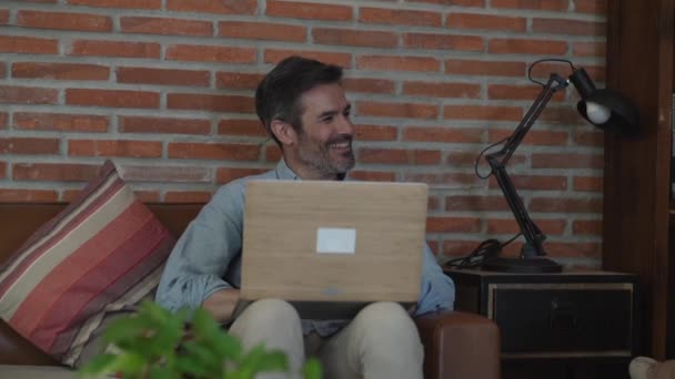 Mature Man Using Laptop Sofa Home — Vídeos de Stock