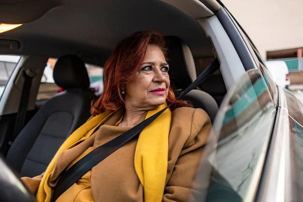 mature woman driving car angry
