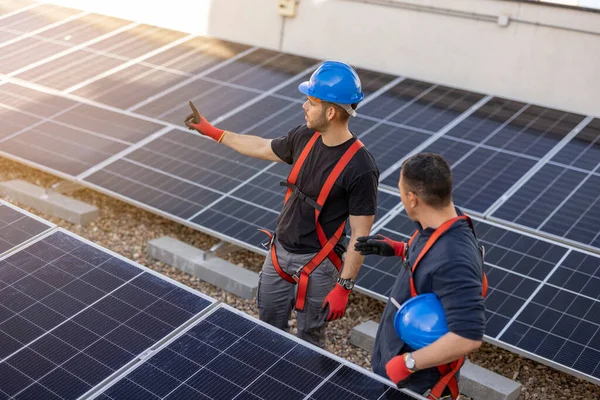 workers installing solar panels, for efficient energy in the city