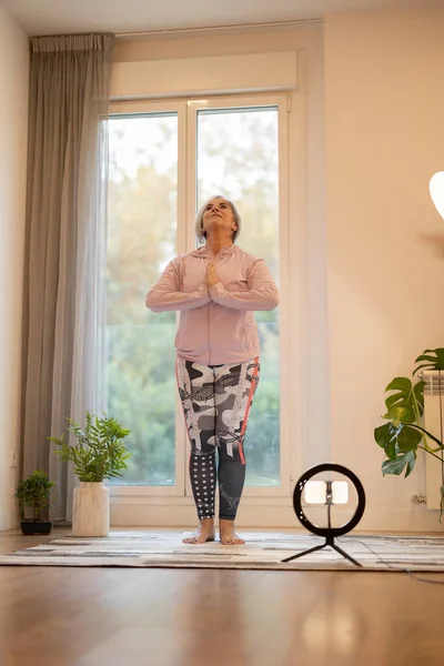 mature woman yoga teacher online classes from home