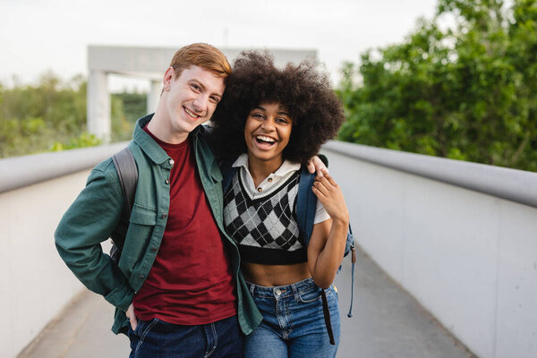 couple students outdoors redhead boy and african girl, millennial, generation z,