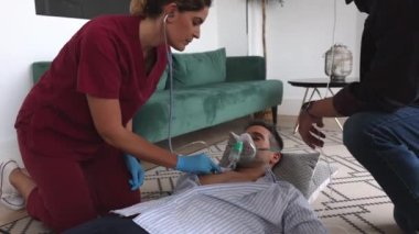 Evde baygın bir kadın doktor tarafından tedavi ediliyor.