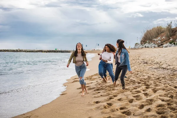 stock image diverse women running on the beach