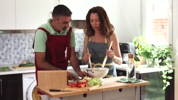Mature Couple Cooking Home Looking Recipe Digital Tablet — Vídeos de Stock